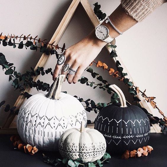 Gorgeous boho inspired black and white pumpkins and a wooden frame plus eucalyptus