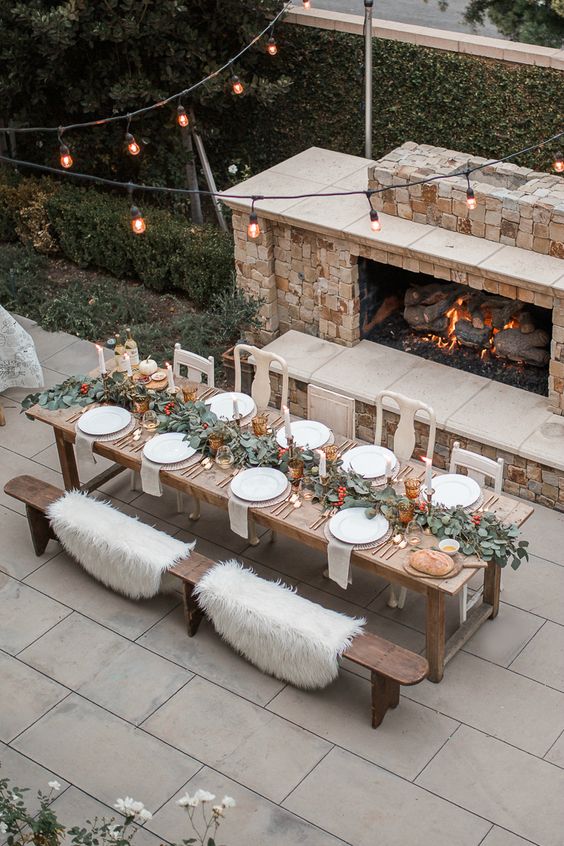 a fireplace and faux fur throws on the benches willmake sitting cozier and much warmer