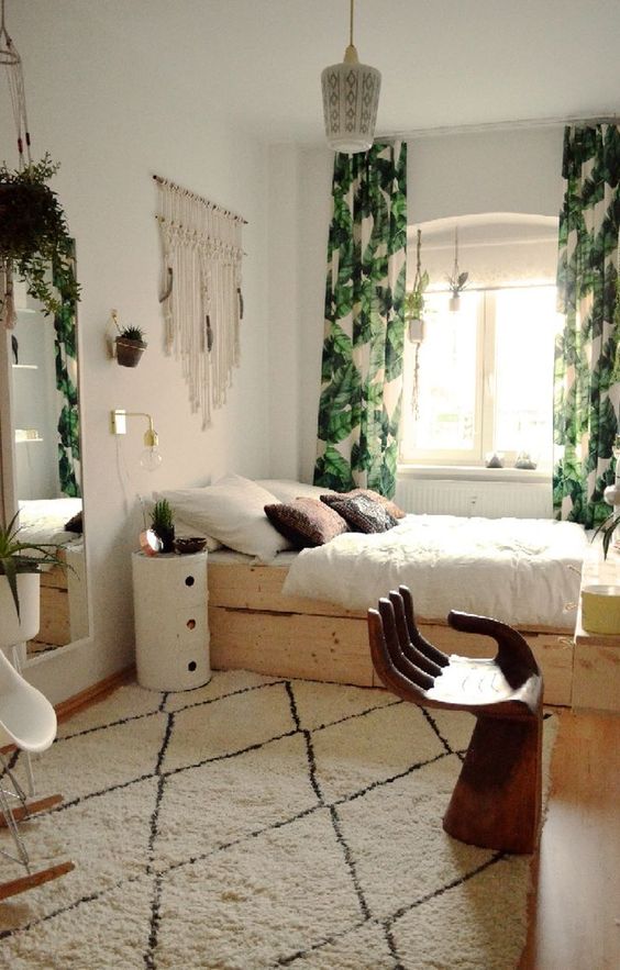 leaf printed curtains dominating in this boho bedroom and a neutral rug that doesn't stand out much