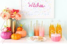 15 a colorful Halloween drink bar with bright pumpkins, ombre glasses and a sprinkle sign, a lush floral centerpiece