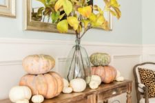 15 a cozy Thanksgiving console with fabric baskets, heirloom pumpkins and fall leaf branches in a vase