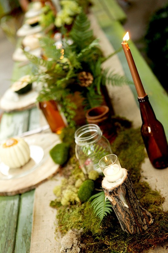 a table runner of moss, foliage and moss balls for a Thanksgiving table setting