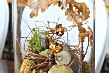 16 a beautiful fall display with moss, fall leaves, berries,  fake bird and a fake nest of twigs for a rutic feel
