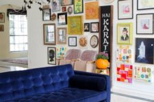 16 a colorful space with a bold gallery wall with various artworks and mirrors