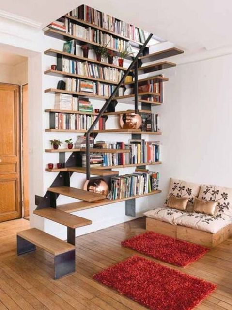 a floating metal and wood staircase integrated into the bookshelves on the wall