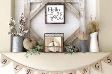 17 a rustic fall or Thanksgiving mantel with cotton, fabric pumpkins, herbs and a sign in a frame