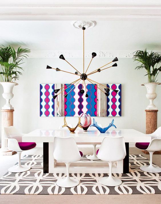 a bold printed artwork makes a statement and a printed rug is a more neutral addition to the dining room