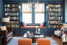 18 a colorful interior in blue and orange with lots of bookshelves that frame the window