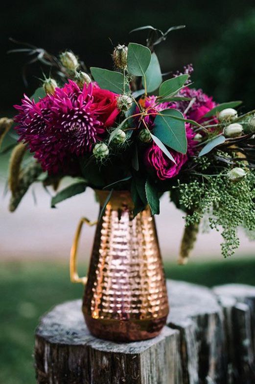 a copper pitcher with purple dahlias and fresh greenery for a bright Thanksgiving centerpiece