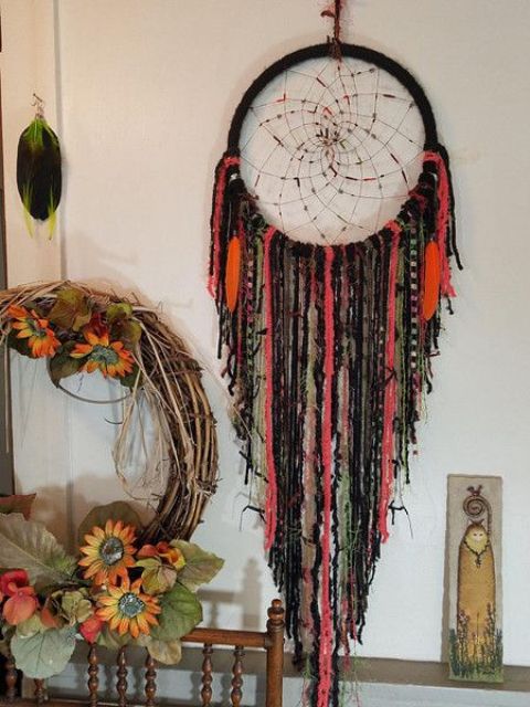 A gothic boho drema catcher in bold orange and black is a cool Halloween decor option