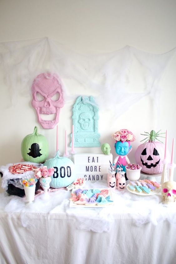 a pastel Halloween candy bar with painted pumpkins, skulls and ugly dolls