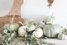 19 a neutral fall mantel with light green and white pumpkins plus seeded eucalyptus is great for Thanksgiving