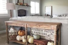 19 a rustic console with heirloom pumpkins and a basket, plus a cool sign