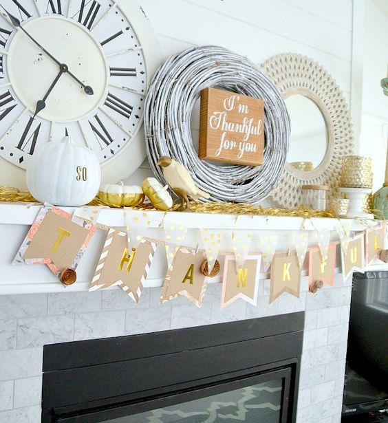 a simple banner of paper, painted pumpkins, a wreath and a framed mirror plus a fake bird