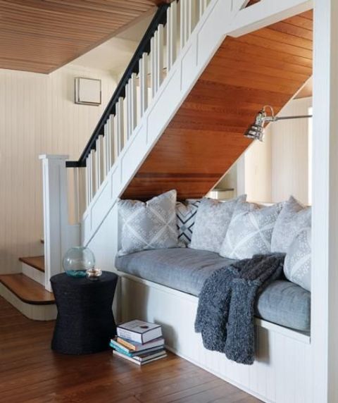 use the space under the stairs for an ultimate comfortable nook for reading or having a nap