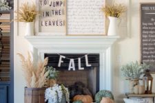 20 a couple of signs and wheat on the mantel and heirloom pumpkins in a tray plus dried herbs in rustic containers