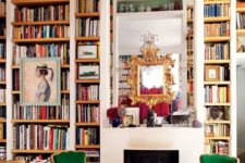20 a maximalist space with lots of books by the fireplace and colorful furniture and metallics