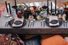 22 a gorgeous boho chic picnic setting for Halloween with lush florals, candles and black chargers