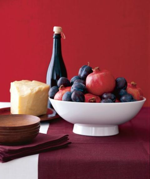 A simple bowl centerpiece with pomegranates and plums is a great last minute idea for Thanksgiving