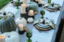 24 green heirloom pumpkins, green glasses and colorful floral print napkins dot the table with touches of color