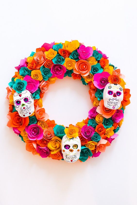 a super colorful paper flower wreath with painted sugar skulls is a chic idea that can be DIYed
