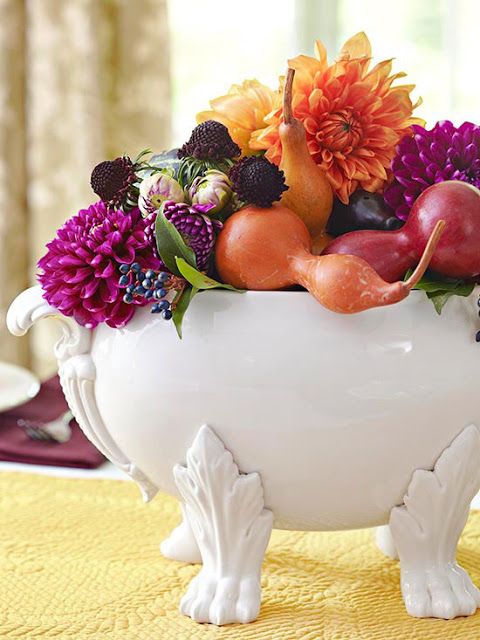 a vintage soup bowl filled with fall fruits and veggies, bright blooms and berries in bright jewel tones