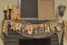 25 rustic and natural Halloween fireplace and mantel with heirloom pumpkins, a banner and some firewood