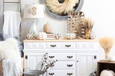 26 rustic fall or Thanksgiving console styling with wheat, pumpkins, cotton and faux fur for a chic look