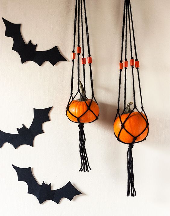 these fun hangers of blakc macrame and orange pumpkins are a simple and cute boho decoration for Halloween