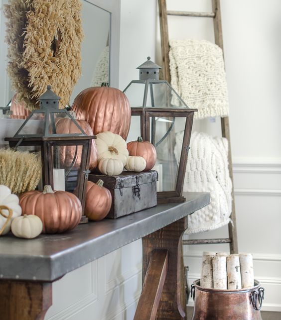white and matte copper pumpkins are a great idea for simple Thanksgiving console or mantel decor