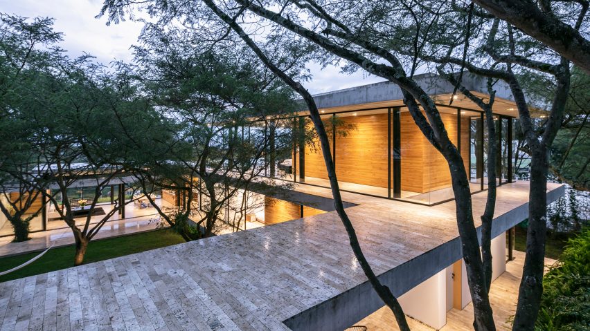 This contemporary house in Ecuador features three wings and trees growing through the house
