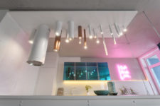 02 The kitchen is illuminated with tube-like lamps and a pink neon light