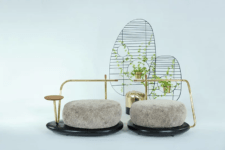 The sofa is composed of two parts with a side table and even some space for flower pots