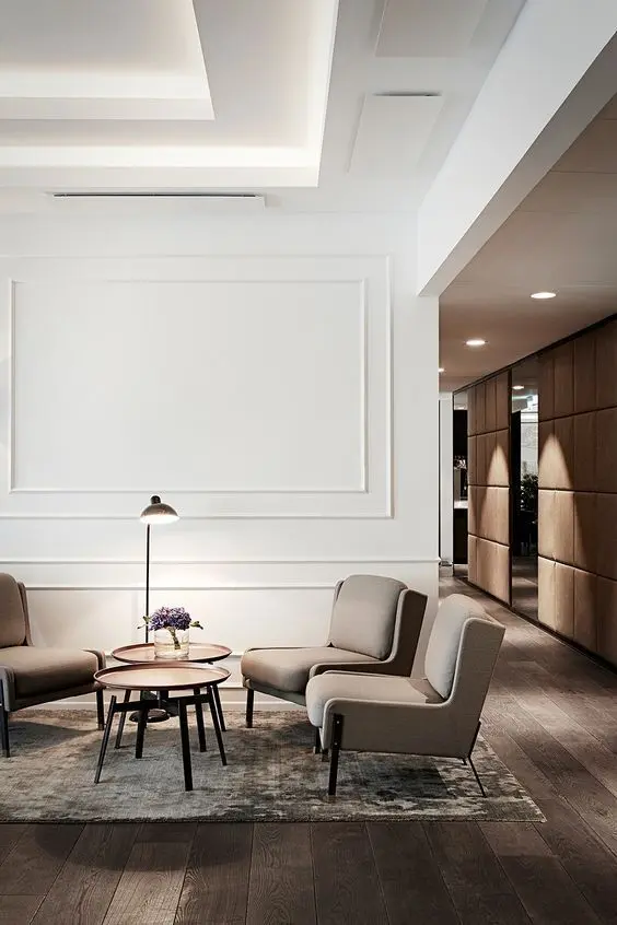 a contemporary sitting space with shapely furniture and wall panels for a chic touch and refined feel