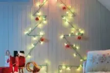 02 a cute wall-mounted Christmas tree done with green lights and red and white ornaments for a traditional feel