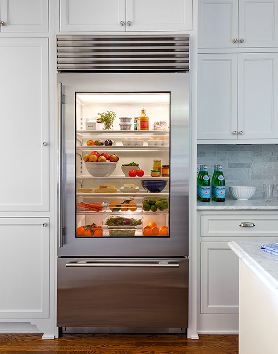 a glass door fridge is a cool idea for a contemporary space, though it needs more maintenance, it instantly adds a modern feel