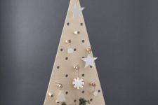 03 a pegboard Christmas tree with plywood ornaments hanging on hooks is an ultra-modern idea to DIY