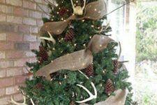 03 a rustic feel is brought with burlap ribbons, pinecones, antlers and lights is a cozy outdoor decoration