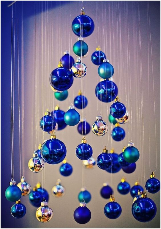 a small Christmas tree of matte and shiny blue ornaments and little silver ones is a whimsy and creative DIY idea