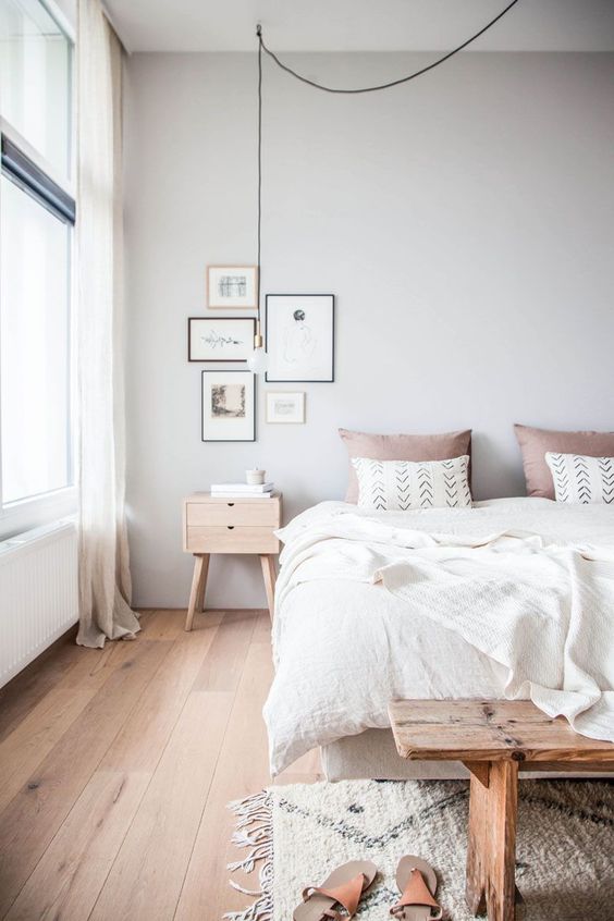 A welcoming and airy Scandinavian bedroom with all natural linens and a touch of dusty pink