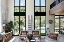 03 a welcoming modern rustic living room in neutrals, with double height windows and an airy feeling