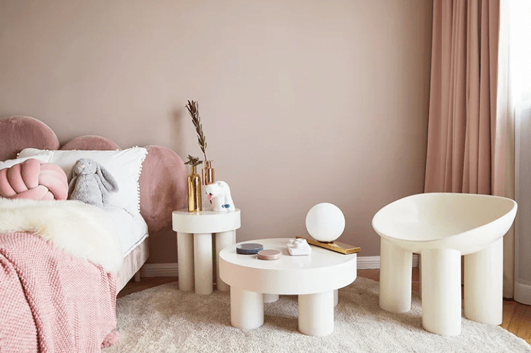 The kid's room is done in neutrals and tender pink tones, gilded touches add a glam feel