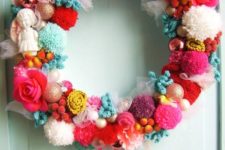 05 a colorful and whimsy Christmas wreath of pompoms, fake birds, ornaments, ribbons and roses