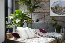 05 a neutral industrial space done with boho touches, animal skins, brickwork and potted plants make it catchy