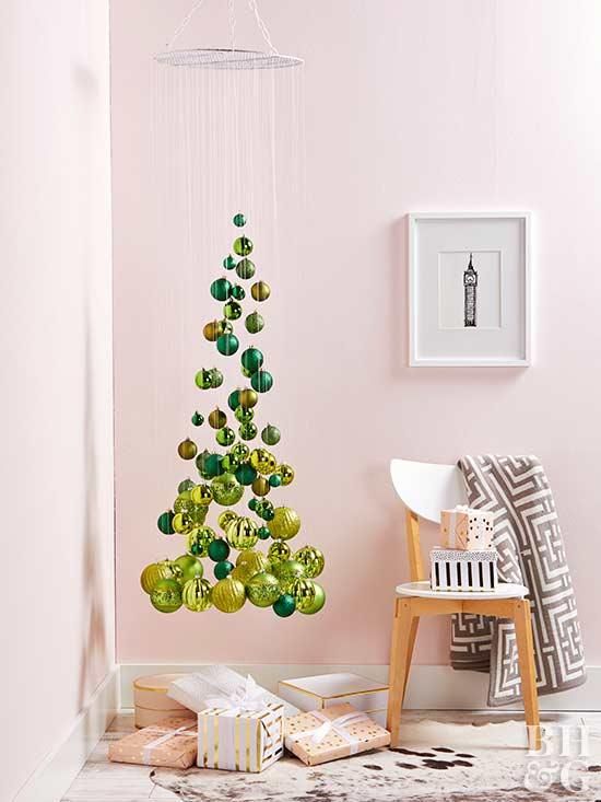 a small and elegant suspended Christmas tree of emerald and gold ornaments, shiny and glitter ones is an airy idea