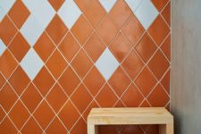 06 The master bathroom is done in orange and white tiles shaped as diamonds to highlight the jewelry inspiration