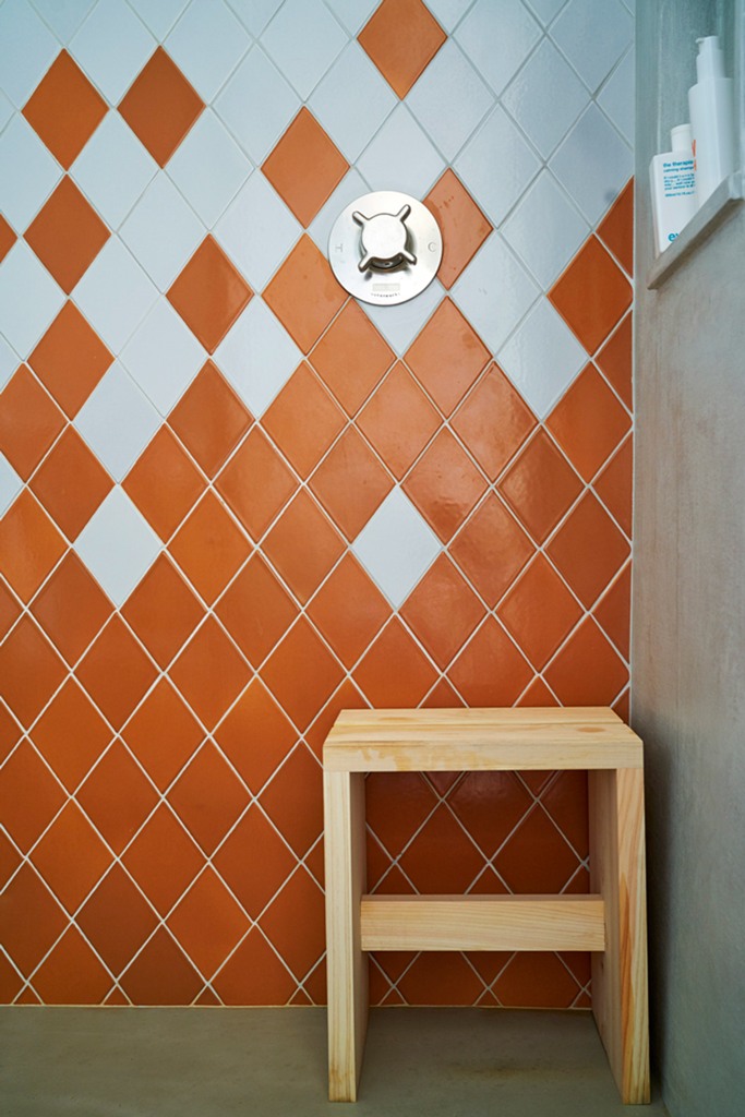 The master bathroom is done in orange and white tiles shaped as diamonds to highlight the jewelry inspiration