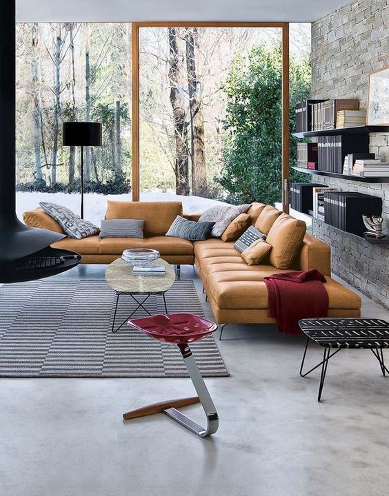 a contemporary living room with a glazed wall and a touch of color with accessories