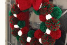 07 a Christmas pompom wreath of white, green and red pompoms and a knit bow