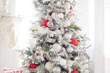 07 a flocked Christmas tree decorated with white, silver and red ornaments plus ribbons and banners